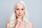 Photo of beautiful naked focused aged lady look mirror serious facial expression arm on chin isolated grey color