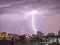 Photo of beautiful powerful lightning over big city, zipper and thunderstorm, abstract background, dark blue sky with bright