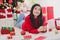 Photo of beautiful thoughtful girl wear xmas red pullover typing congratulations modern gadget indoors home room