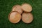 Photo of beautiful wooden coasters on the grass