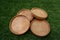 Photo of beautiful wooden coasters on the grass