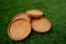 Photo of beautiful wooden coasters on the grass