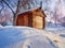 Photo of beautiful wooden outhouse with roof under the snow