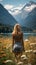 photo from behind of adventurous traveler woman standing in a field of yellow flowers looking at the mountains and beautiful lake