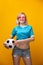 Photo of blonde in pink glasses with soccer ball on orange background
