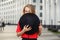 Photo blonde in red jacket covering face with black hat