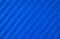 Photo of the blue carbon fiber texture. Blue vinyl film for pasting sports cars. Racing style. Sporty blue background.