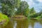 Photo from the boat. Turn of River a right angle with a steep bank with trees on it. Landscape of Teteriv river, which flows throu