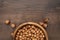 Photo of a bowl full of hazelnuts on the brown wooden table