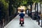 Photo of boy`s back driving his red motorcycle