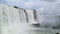 Photo of the Brazilian side of the Iguazu Falls, where you can see the main waterfall, the blue sky with some clouds