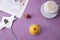 Photo of breakfast on a pink background. Latte coffee and a chic yellow dessert in coconut. Dessert spoon.