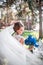 Photo of the bride from the back, wedding dress on a girl, the bride in the forest. veil in the wind