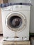 Photo of a broken washing machine that has caught fire