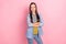 Photo of brunette curious young lady look promo crossed palms wear jeans jacket isolated on pastel pink color background