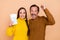 Photo of brunette hairdo couple hold passport hands fists wear sweaters isolated on beige background