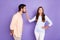 Photo of brunette people man send air kiss woman refuse hand waist ignore isolated on purple color background