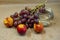 Photo of a brush of grapes with nectarine with a glass on a beige background