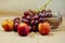 Photo of a brush of grapes with nectarine with a glass on a beige background