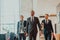 Photo of a business team in suits walking in a modern corporation. Successful business team. Selective focus