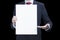 Photo of businessman wearing suit presenting blank poster on black background