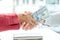 Photo of Businessmen shake hands and dollar note, sign a contract to bribe corruption in the company. The concept of bribery and