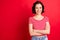 Photo of businesswoman who just starter her career and is ready to reach top while isolated with red background