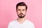 Photo of calm focused concentrated bearded guy look camera wear white t-shirt isolated pink color background