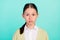 Photo of calm focused dilligent pupil lady serious look camera wear green top cardigan isolated teal color background