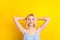 Photo of calm nice blond short hair lady hands head wear blue top isolated on vivid yellow color background