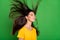 Photo of calm peaceful nice young woman spring wind blow hair good mood isolated on green color background