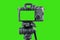 Photo camera. Digital or Dslr camera on tripod. Green screen or Chroma key. Photographer or videographer