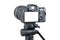 Photo camera. Digital or Dslr camera on tripod. Photographer or videographer studio for recording film project.