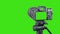 Photo camera with lens. Digital or Dslr camera on tripod. Green screen or Chroma key. Photographer or videographer studio