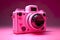 Photo camera, pink lighted camera on dark background
