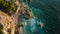 This photo captures an aerial perspective of the vast ocean and rugged rocks along the coastline, Aerial perspective of the sea