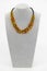 A photo captures a black-corded necklace adorned with polished Baltic amber. The golden-brown hues of the amber, set against the