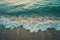 A photo capturing the dynamic movement of waves as they crash onto the sandy beach, A serene view of ocean waves gently meeting