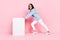 Photo of carefree cheerful lady wear trendy clothes sportswear push big white figure empty space have fun isolated on