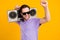 Photo of carefree cool guy hold boombox have party fun wear violet t-shirt isolated yellow color background