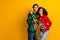 Photo of carefree cute guy girl dressed christmas ugly print pullovers showing thumb empty space isolated yellow color