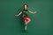 Photo of carefree funky lady dance stand tiptoe wear elf costume hat high socks isolated green color background