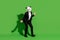 Photo of carefree joyful man corporate event dance wear panda mask black tux shoes isolated on green color background