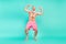 Photo of carefree old man dance beach party rejoice raise arms wear pink shorts barefoot isolated teal color background