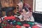 Photo of caring trustful old couple grandma write letter grandpa touch shoulder wear ornament sweater home indoors