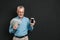 Photo of caucasian retired man 60s with gray hair holding mobile