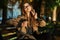 Photo of caucasian woman drinking takeaway coffee while sitting on bench in sunlit alley