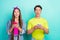 Photo of celebrate brunette young couple search online wear yellow pink t-shirts jeans isolated on teal color background