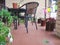 Photo of a chair, table and plants  on a terrace.