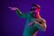 Photo of charming attractive young man wear sunglass dance night club isolated on purple neon color background